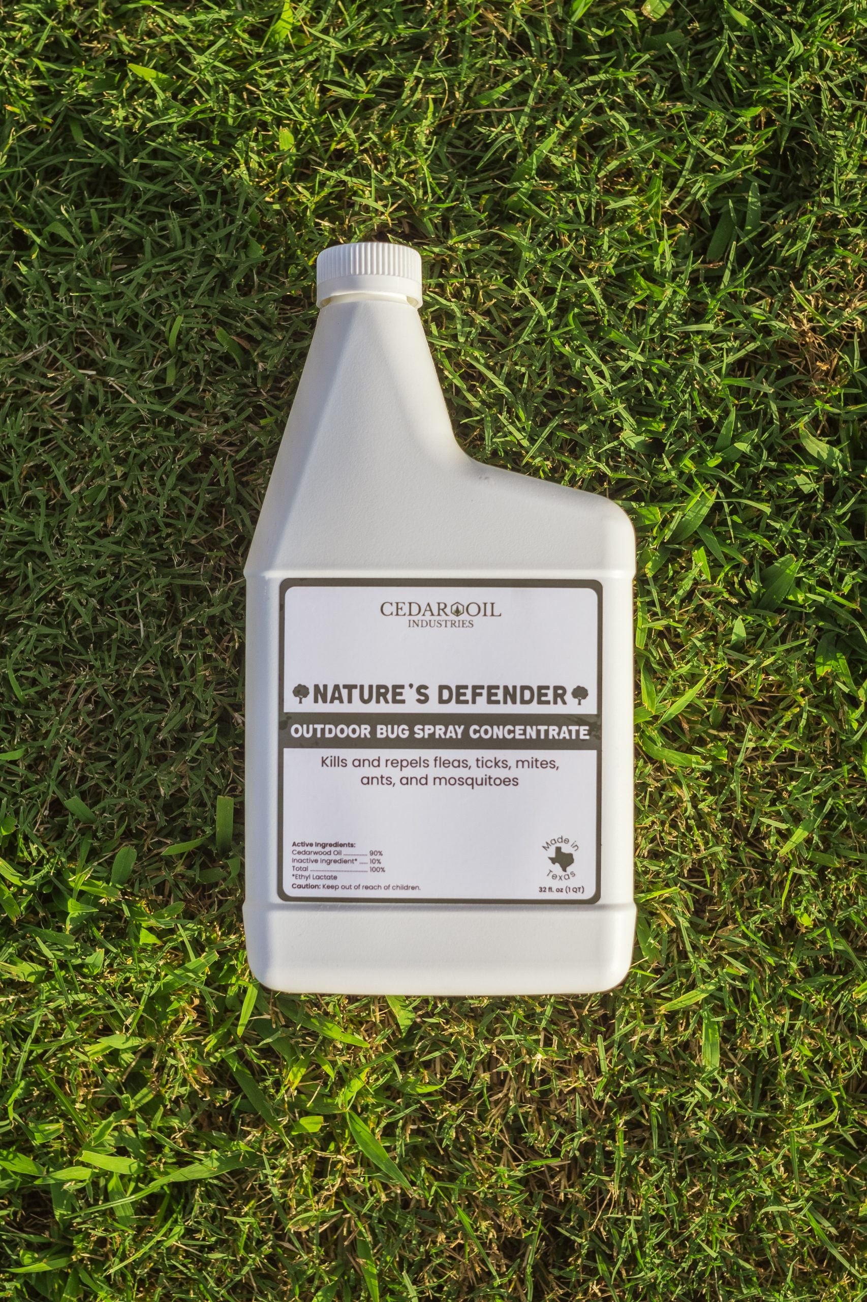 Nature's Defender - Outdoor Bug Spray Concentrate bottle on grass